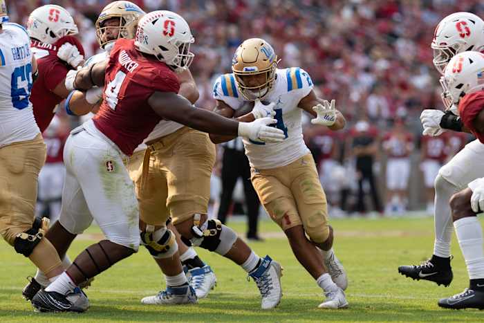Booker (4), works through a block on a run play against UCLA.